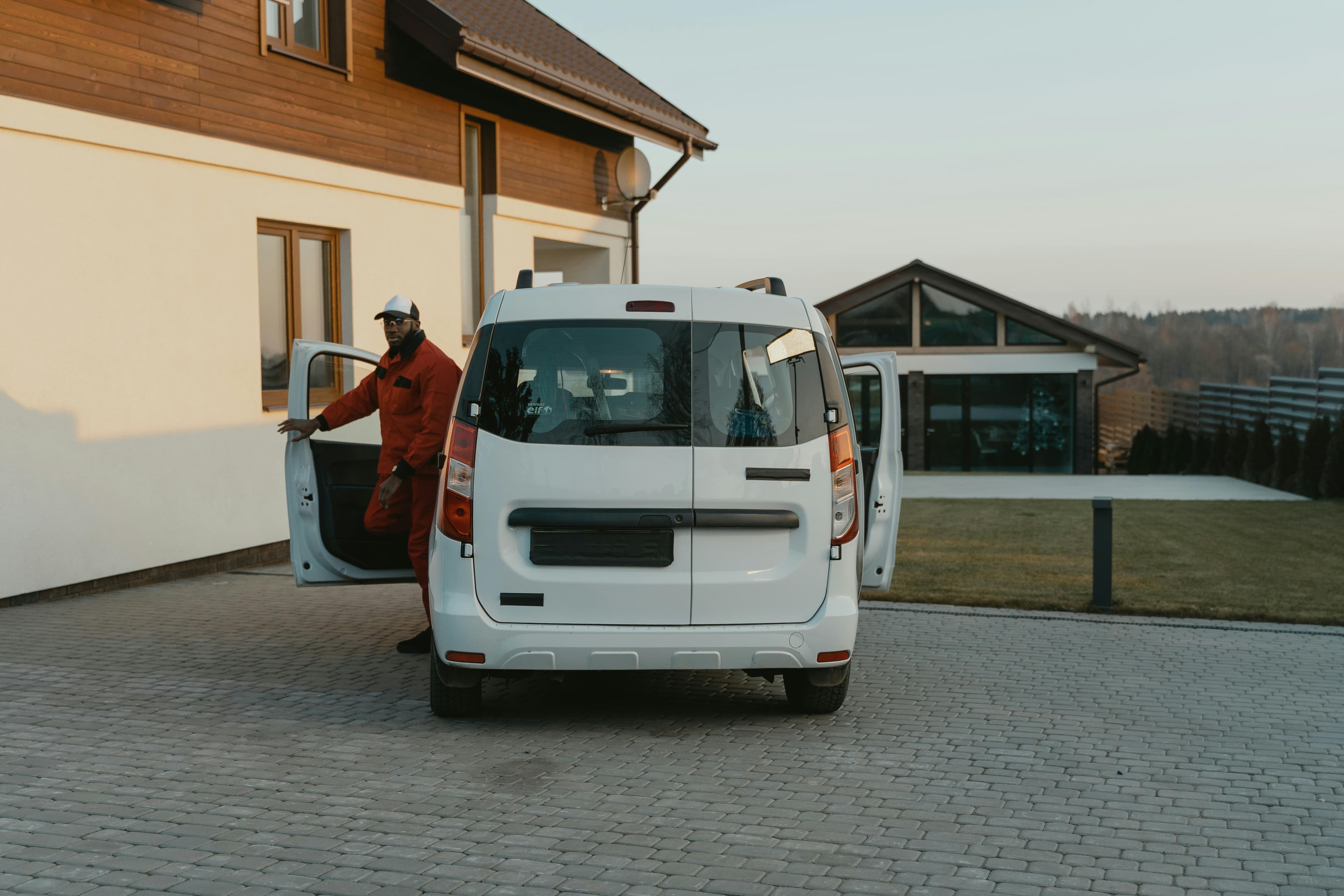 HVAC service van parked outside a residential home in early evening light