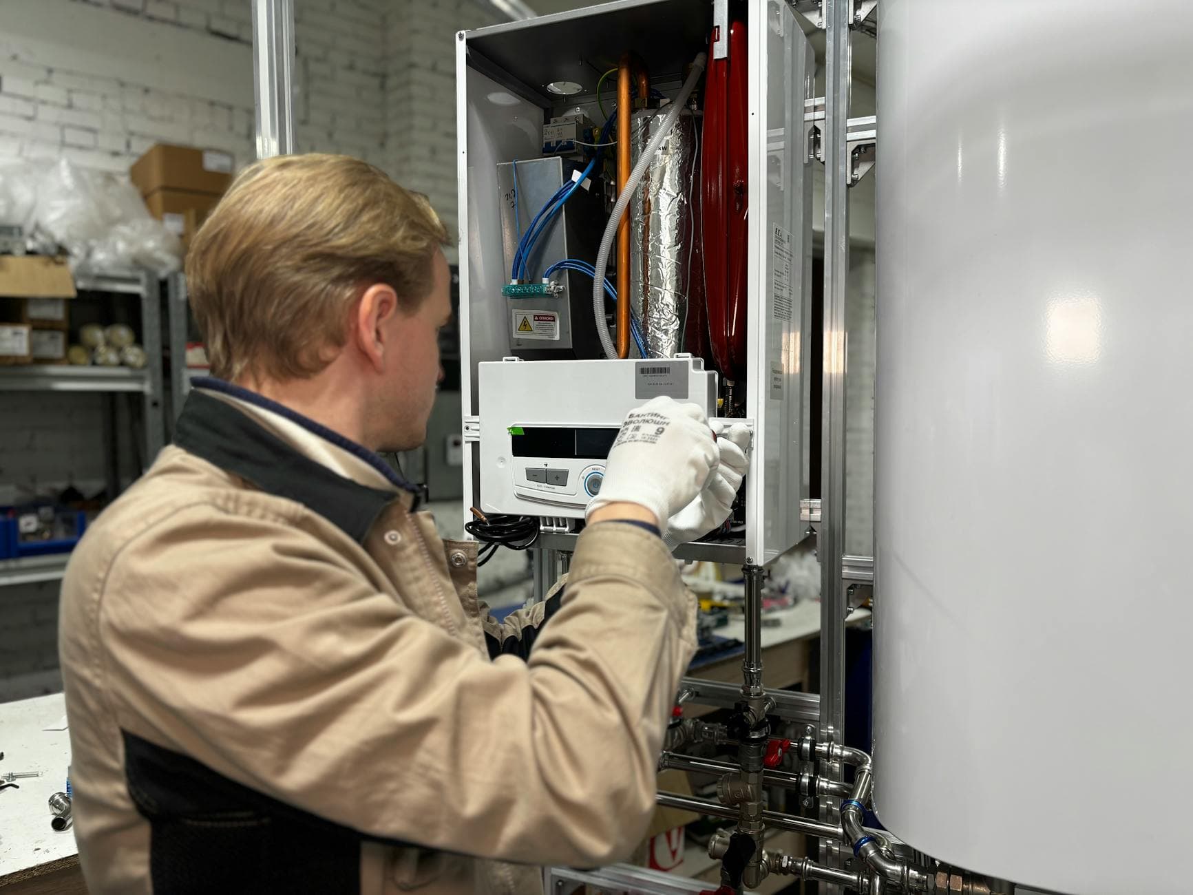 New residential water heater installed in a utility closet